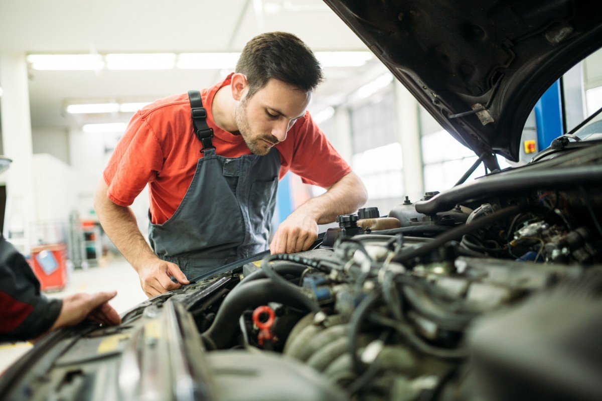 mechanic working on car in garage